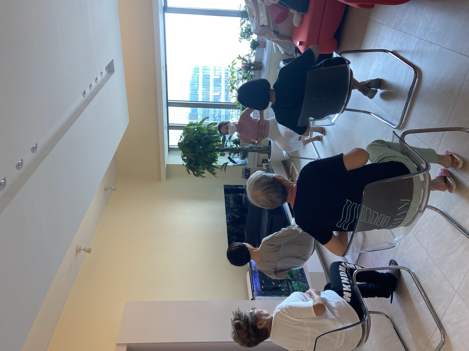 A coach leading a seated exercise session for older adults